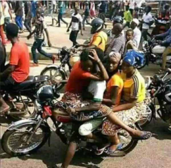 Photo Of A Man Carrying A Lady At The Front Of A Bike Goes Viral